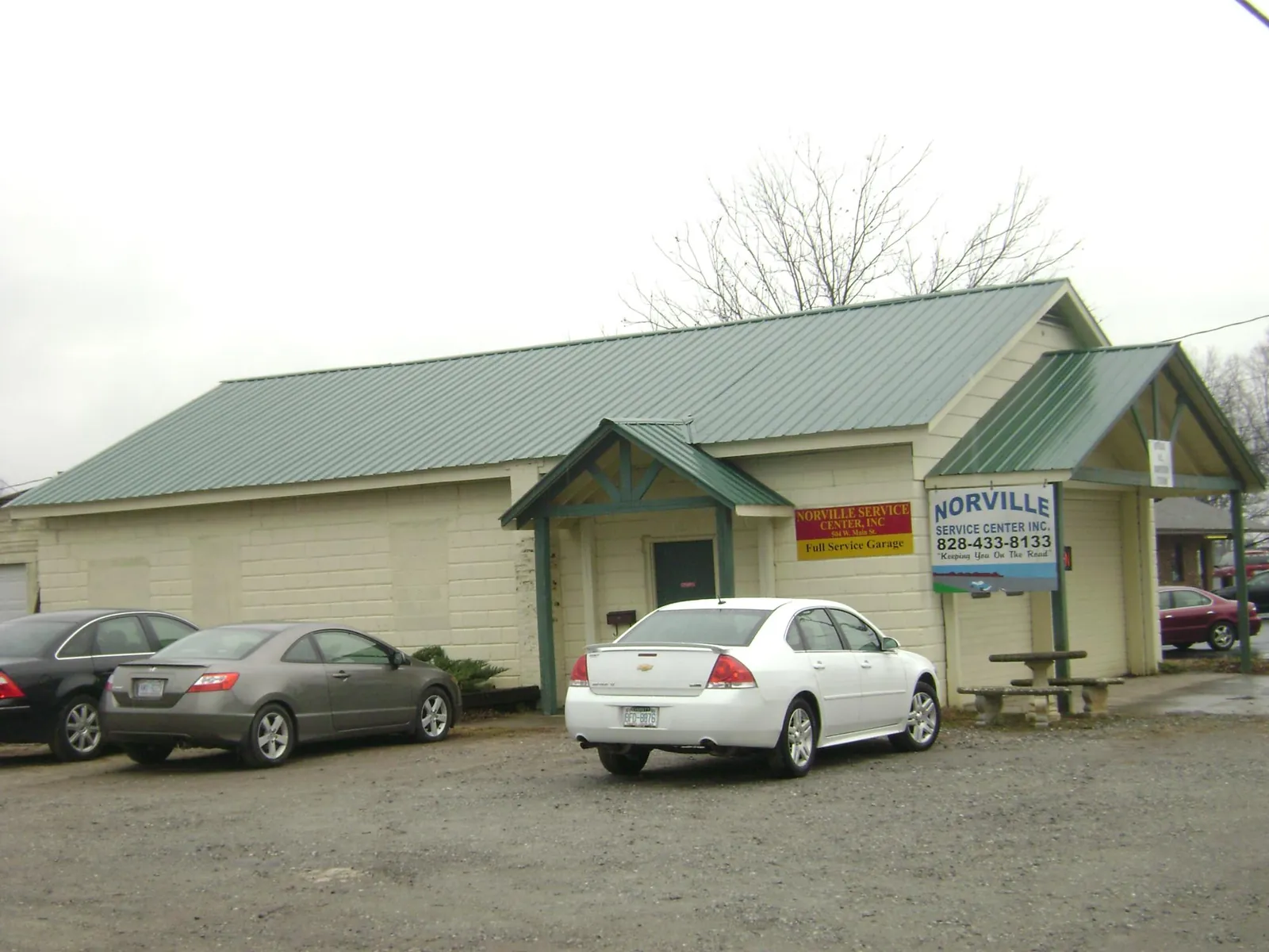 Green metal roof on a service garage with a covered entry in Three Springs