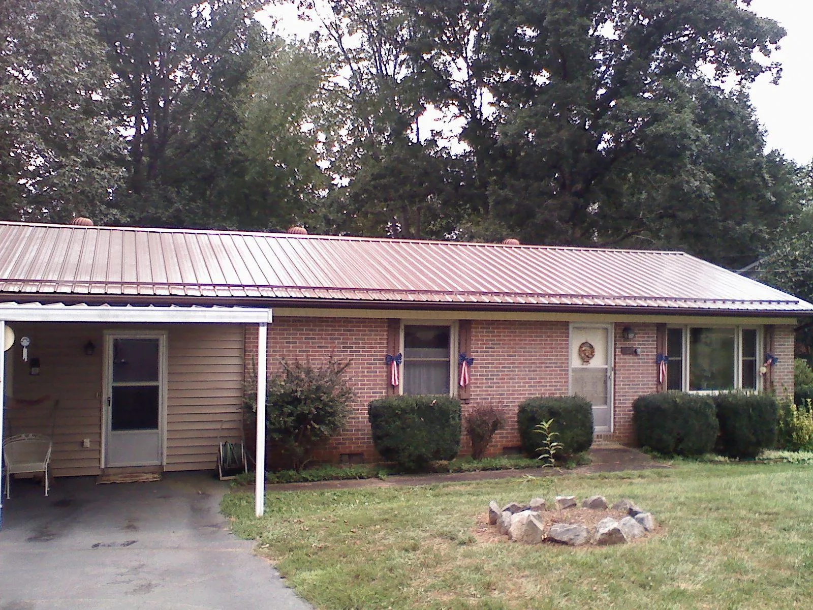 Bronze metal roof and carport on a brick ranch home — Roof Repair work by our crew in Three Springs